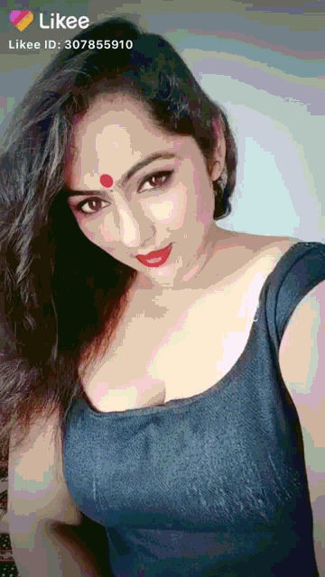 a woman with a red bindi on her forehead is on a likee page