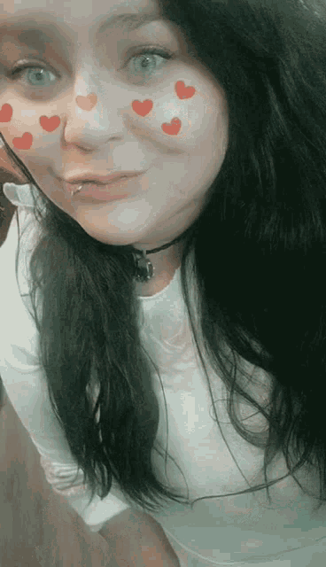 a woman with red hearts on her face