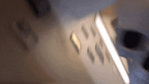 a blurry picture of a remote control with the letters s and t on it