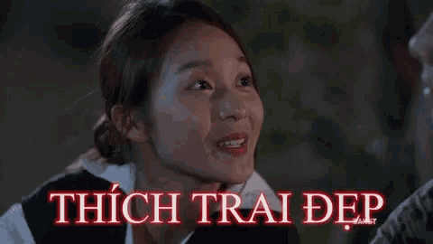 a close up of a woman 's face with the words thich trai dep written in red .