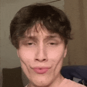 a close up of a person making a funny face with their mouth open