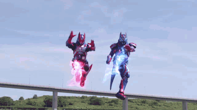 a couple of robots are flying through the air while fighting each other .