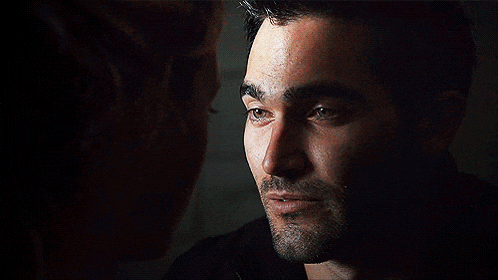 a close up of a man 's face with a woman looking at him