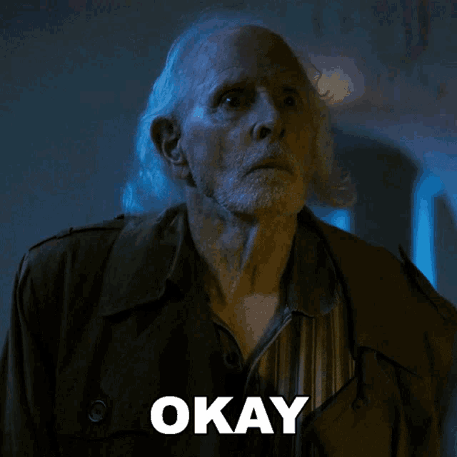 an older man with gray hair and a beard says " okay "