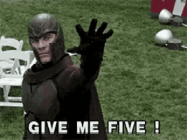 a man in a superhero costume is waving his hand and saying give me five !