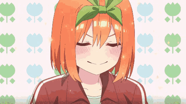 a girl with orange hair and a green headband is smiling