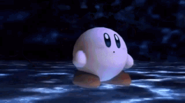 kirby is floating in the water in a dark room .