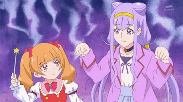 a couple of anime girls are standing next to each other and one of them is holding a wand .