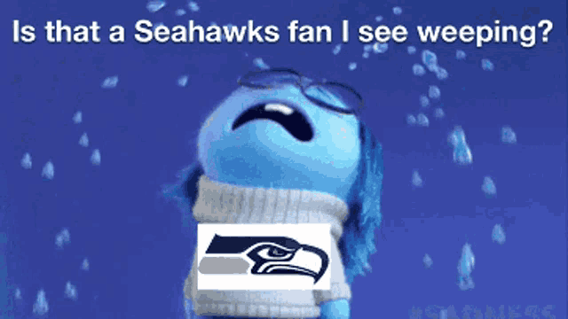 a seahawks fan is crying with a picture of a seahawk on his shirt