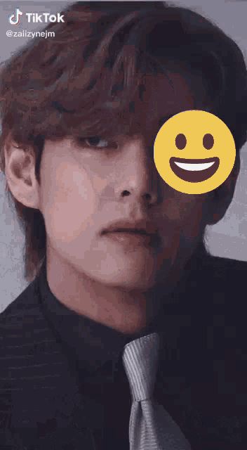 a close up of a man 's face with a smiley face in front of his eye
