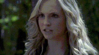 a woman with blonde hair is looking at the camera