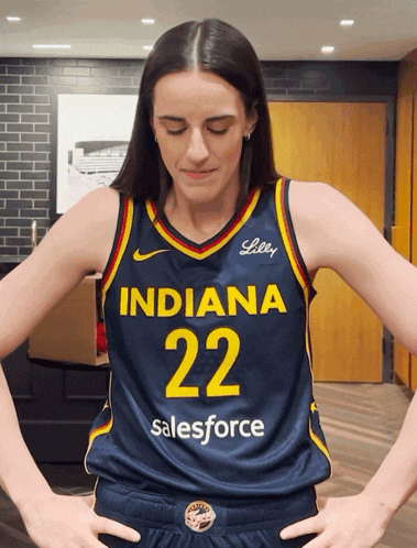 a woman wearing a jersey that says indiana 22 salesforce