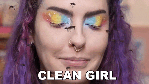 a woman with purple hair and a nose ring is surrounded by mosquitoes .