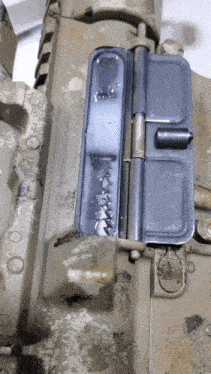 a close up of a dirty gun with a black dust cover on it