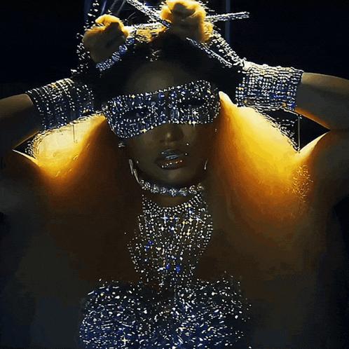 a woman wearing a mask with rhinestones on her eyes