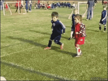 a boy and a girl are playing soccer on a field and the girl has the number 11 on her jersey