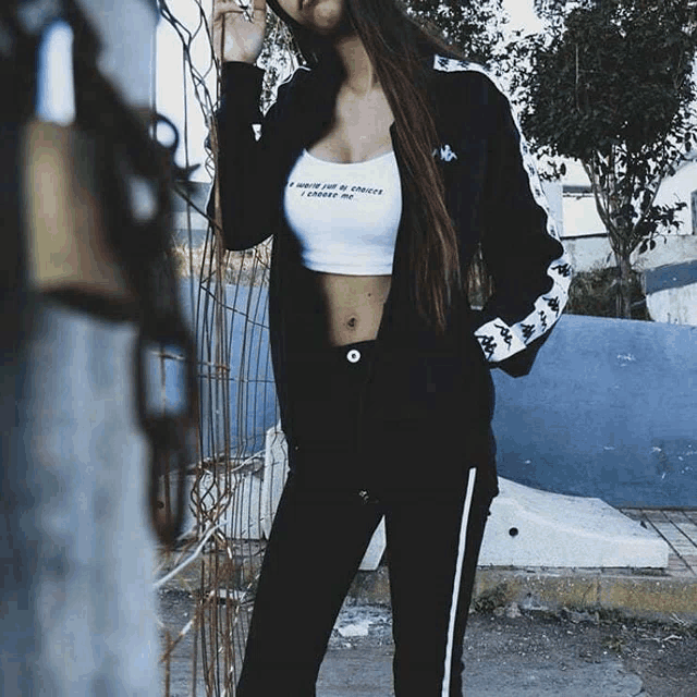 a woman in a kappa jacket and crop top