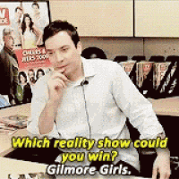 a man is sitting at a desk with a microphone in his ear and says which reality show could you win ?