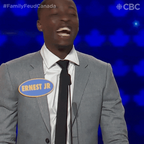 a man in a suit and tie has a name tag that says ernest jr on it