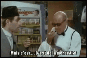 a man in a tuxedo is talking to another man in a hat and bow tie .