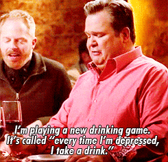 a man in a red shirt is playing a new drinking game called every time i 'm depressed
