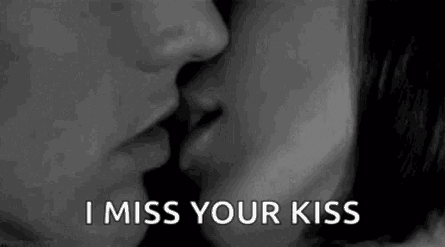 a black and white photo of a man and woman kissing with the words `` i miss your kiss '' written below them .