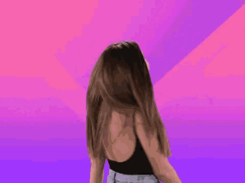 a woman in a black tank top is dancing in front of a purple background that says wonderful