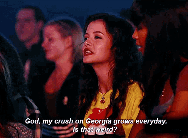 a girl in a yellow shirt says god my crush on georgia grows everyday is that weird