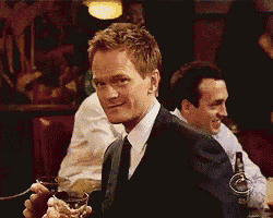 a man in a suit and tie is holding a glass in his hand