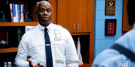 a police officer in a white shirt and tie is holding a key and saying yas queen .