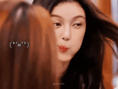 a close up of a woman making a funny face while looking at the camera .