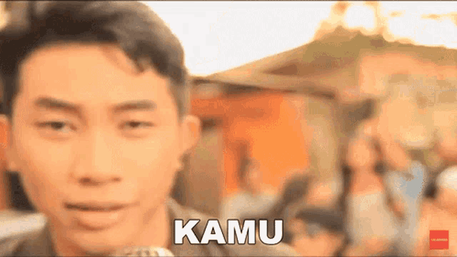 a blurry picture of a man with the word kamu in front of him