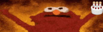 elmo from sesame street is holding a cake with candles on it in front of a fire .