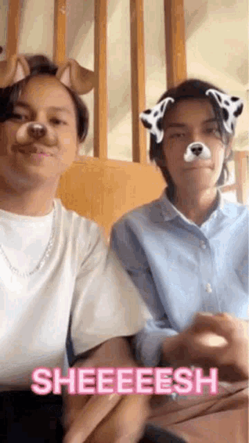 a man and a woman are sitting next to each other with a dog face mask on their faces .