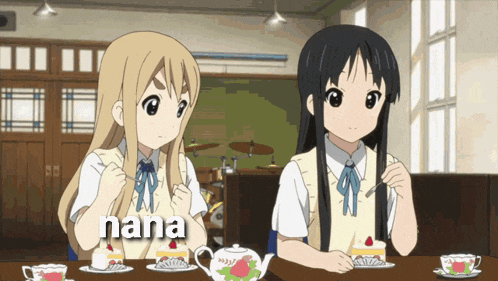 two anime girls are sitting at a table with nana written in the corner