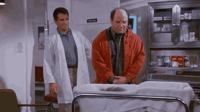 a man in a red jacket is standing next to a man in a white lab coat