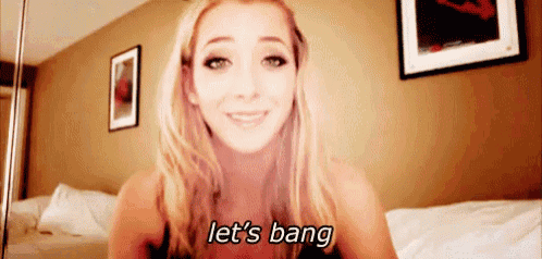 a woman is smiling and saying let 's bang in a bedroom .
