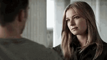 a man and a woman are looking at each other .