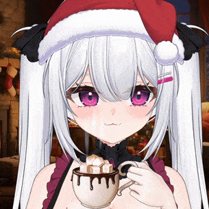 a girl wearing a santa hat is holding a cup of hot chocolate with marshmallows