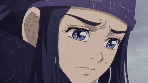 a close up of a girl 's face with blue eyes and a purple headband