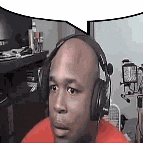 a bald man wearing headphones and a red shirt