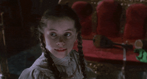a woman in a white shirt is sitting in a chair