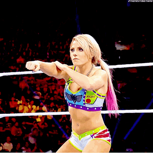 a woman in a wrestling ring wearing a top that says bliss on it