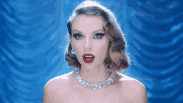 a woman wearing a pearl necklace and red lipstick