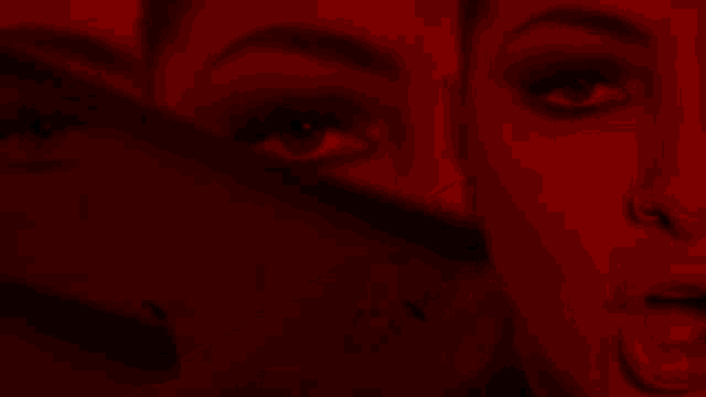 a close up of a woman 's face in a red light