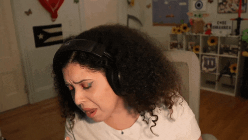 a woman wearing headphones with the letter t on the bottom