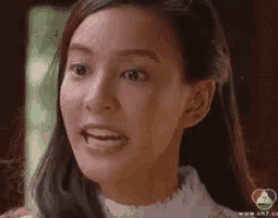 a close up of a woman 's face with a tear running down her face .