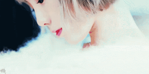 a close up of a woman 's face and neck in a bathtub