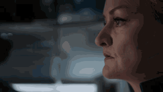 a close up of a woman 's face with her eyes closed