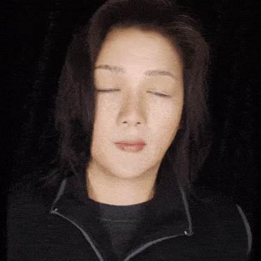 a woman making a shhh gesture with her finger to her lips